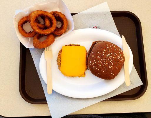 A Harvester with cheese, plain/bun on side. Side of onion rings.