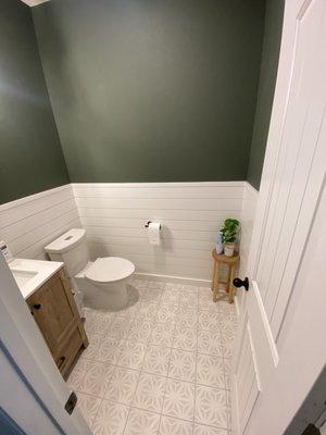 Amazing modern bathroom with natural wood accents and shiplap trim.