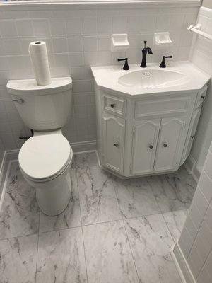 Installed new floor. Painted tile and vanity. Installed new faucet and toilet.