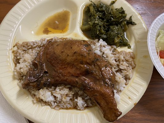 Smothered pork chop, rice n gravy, greens, + salad