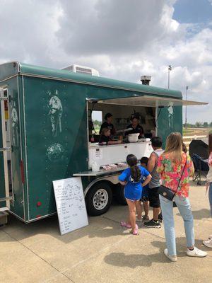 Team work inside the truck.  Cute kid taking orders and friendly family atmosphere.