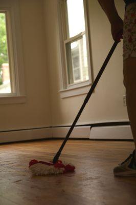 Mopping the floor for a move-out clean.