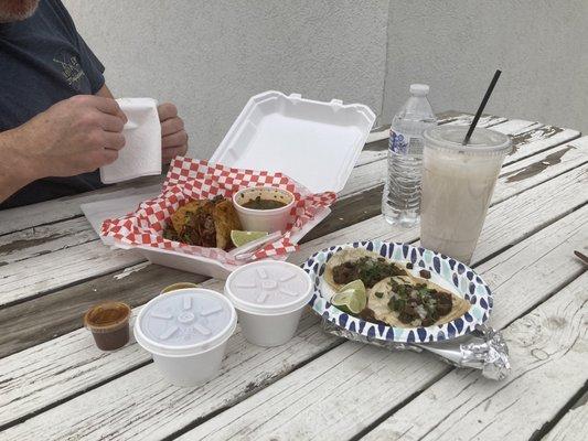 Quesabirria Tacos with Birria Broth, Beans and Rice, Carne Asada street tacos (2), Horchata, red and green salsas.