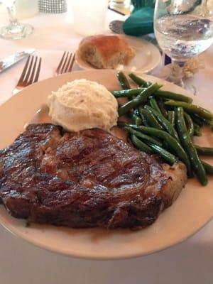 Ribeye steak with mashed potatoes and green beans