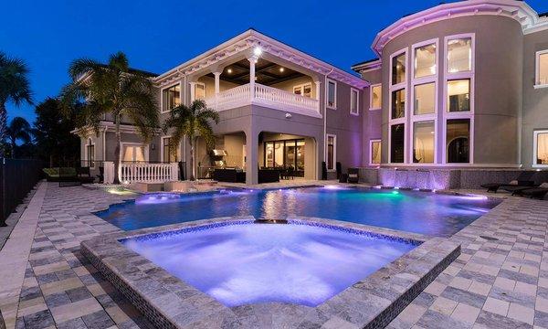 Twilight photo luxury contemporary mansion in Reunion Resort pool deck