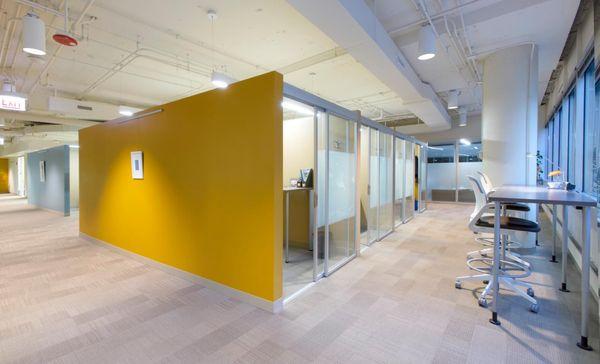 Row of Co-working Office Fronts with Sliding Glass Doors for Open-Air Workstations, which saves on electricity and HVAC costs.