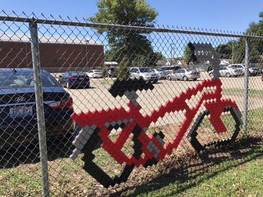 You can't have a Muhammad Ali inspired fence mural without also including his red bicycle.