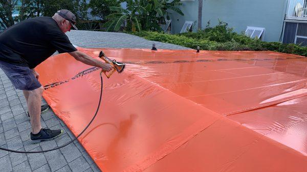 Roofing team sealing a roof wrap from Stormseal.