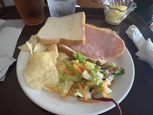 Sunday dinner. Dry bread, slice fake cheese and piece of ham, mystery salad(no dressing) and looks like lays chips. I ordered delivery!