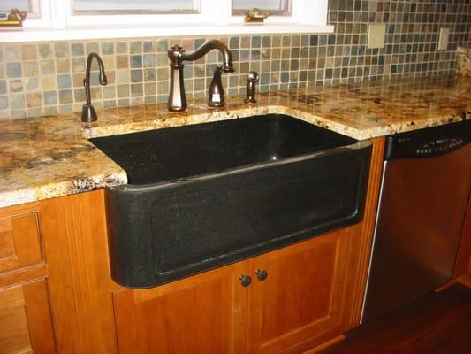 Granite farm house sink with a granite countertop.  