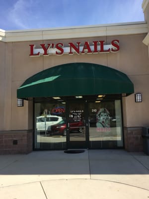 Outdoor view of Ly and their company of nail artists.