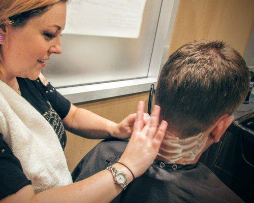 Amanda using her straight razor to finish her guest's neck. A great technique to help extend the life of your style.