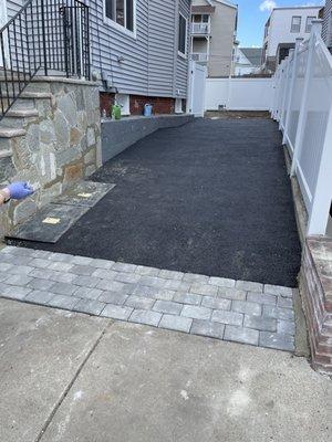 Asphalt driveway with paver entrance