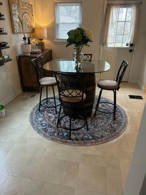 Kitchen with a whiskey barrel as their kitchen table. Easy clean.