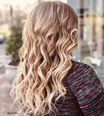 Bold highlights with hand-tied extensions styled with soft curls.