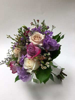 Beautiful bridal bouquet with purples, lavenders, creams and whites.