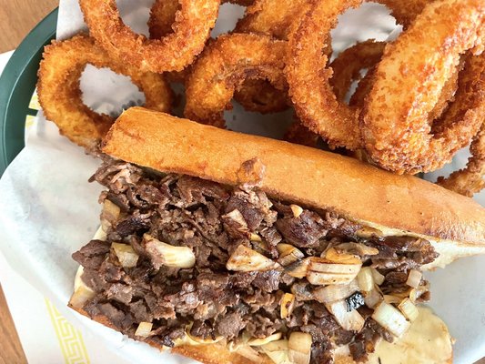 Cheesesteak with mushrooms and onions and onion rings