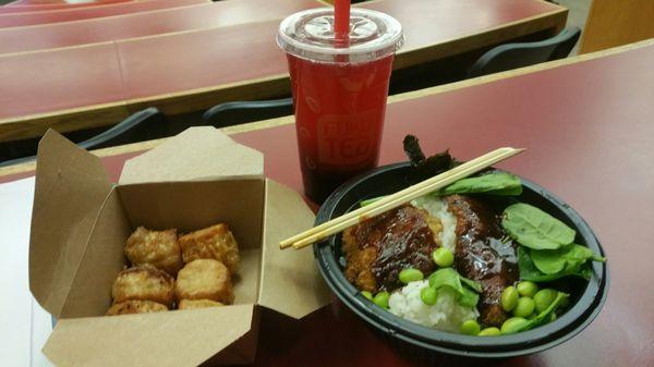 Pork katsu rice bowl with spinach edamame and seaweed with tonkatsu sauce and shrimp shumai on the side