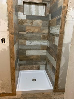 A guy had different size tile and wanted rustic out house look to shower.