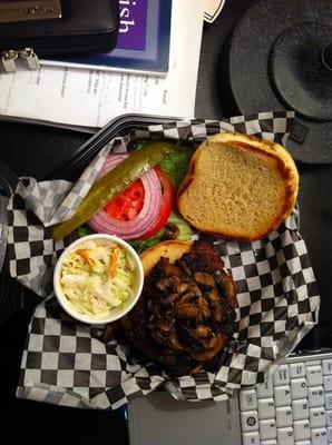 Burger with mushrooms and side of coleslaw