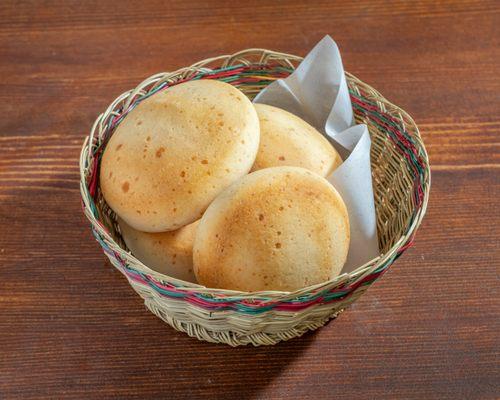 Experience a taste of Colombian tradition with our irresistible Pan de Bono!  Bite into the golden crust and savor its goodness.