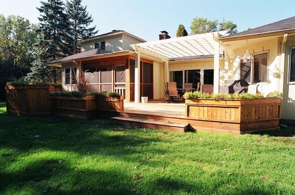 Expansive deck and porch addition featured with a pergola