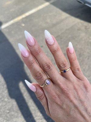 Pink and white nails with glitter accent