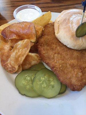 Breaded pork tenderloin sandwich with homemade chips.