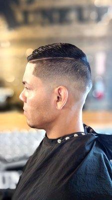 Medium Bald Fade with scissors on top and an added defined part  Stylist: Robyn