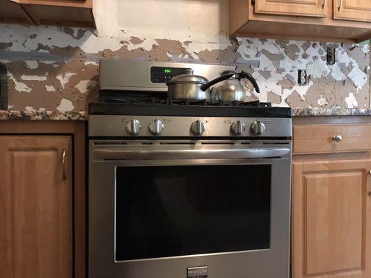 Adamo stone installed a high and low granite counter top in between my stove.