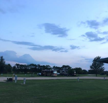 View from shooting park of 50 amp pull thrus on grassy field.