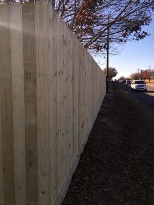 8-foot wood privacy fence with rotboard in Bedford.