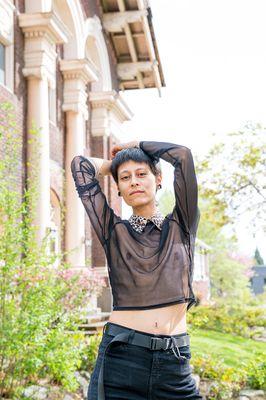 an artist poses with hands on their head in Portland Oregon