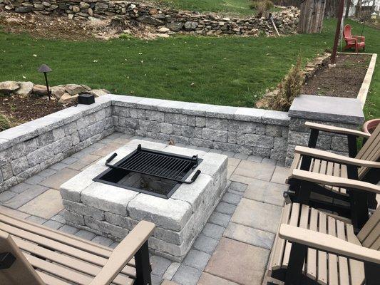 Square fire pit and sitting wall with under cap lighting in Bolton.