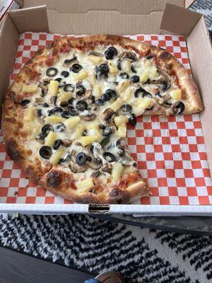 Pineapple pizza with mushrooms, black, olives, and spinach... light cheese