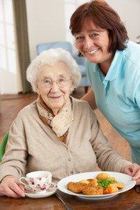 Caregiver taking care of elderly woman