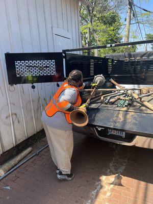 Miscellaneous items being placed on dump truck