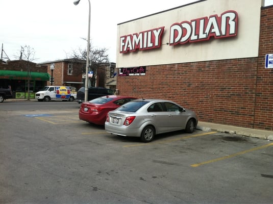 Outside of store from the parking lot. Entrance is on the street side (north) of the building.