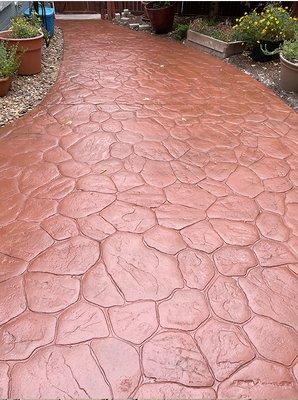 Stamped concrete driveway cleaned and resealed.