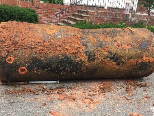 1k gallon tank from Ben's property showing visible signs of staining on the exterior and holes in the tank.