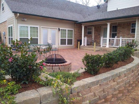 Paver patios with firepit and planter walls.