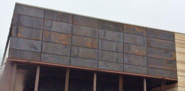 As the corten ages, it will get bright orange to burnt orange and eventurally after years of weathering, black. It is certainly the new look