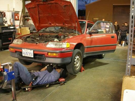 Ruben checks under my car while some other customers talk to Joaquin about a stalled vehicle they needed to retrieve