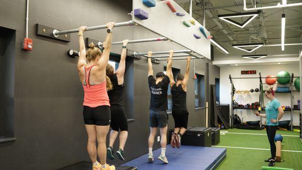 This is one of our ninja warrior class warmups. Hanging from a bar builds strength and mobility in places that often get neglected.