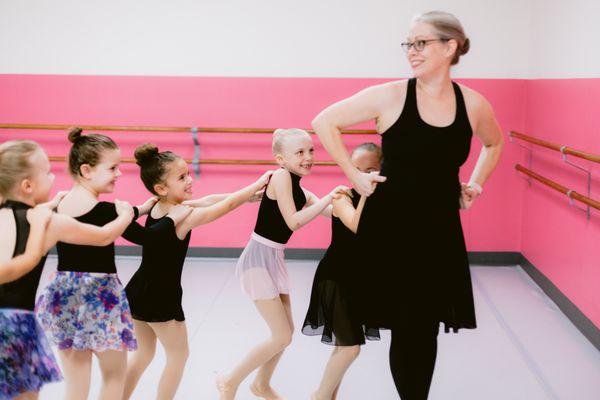 Ballet teacher with young dancers