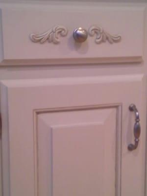 We applied "Decorative Appliques" to oak drawers then painted & glazed entire cabinets. Added brushed nickel hardware.