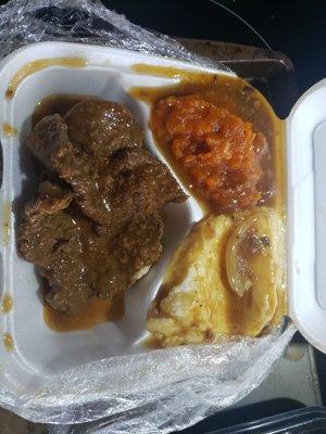 Liver and onions with side dishes of sweet potatoes and mashed potatoes