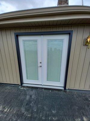 French doors on the second floor balconies with built in blinds.