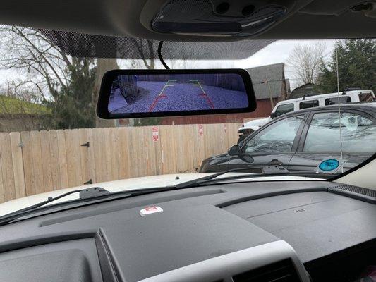 Custom backup and front camera mirror touchscreen showing  rear backup view.