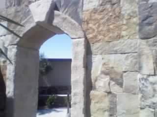 Stone clad garden wall with Granite passage detail.